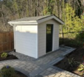 Storage shed set on a paver walkway