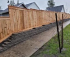 Stepped fence built on a block retaining wall