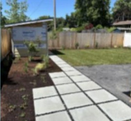 Square paver path beside mulch and lawn