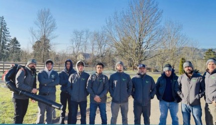 The full New Renovation Construction crew standing together outdoors.