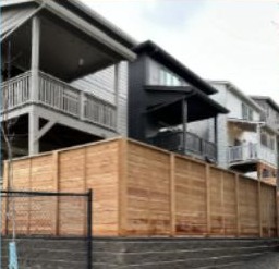 Privacy fence above a new retaining wall